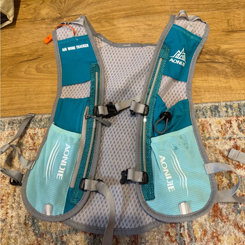 running vest,2 pocket water bottles, one clip on water bottle, and water pouch